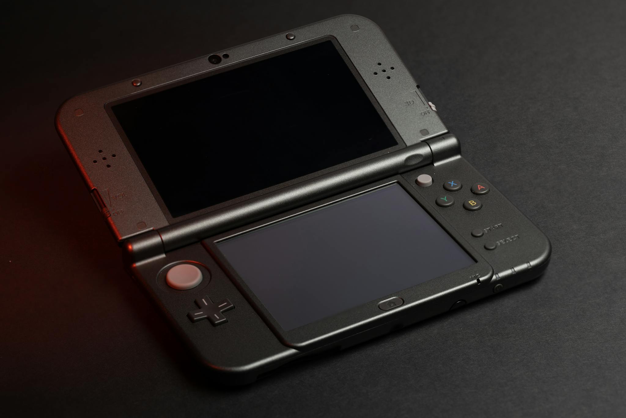 Detailed photo of a Nintendo 3DS console with dual screens and buttons, perfect for gaming enthusiasts.